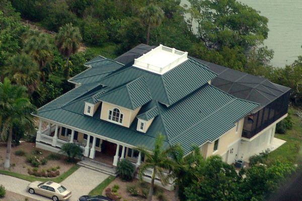 Waterfront home in Naples Florida with metal roof system from Greenling Roofing, Inc. Naples Roofing Contractor