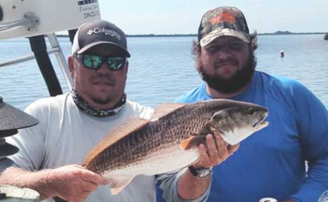 Dan Greenling Jr. and Greenling Roofing team member during team fishing trip | Naples Roofing Contractors