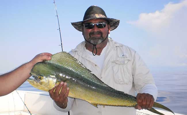 Dan Greenling Sr. with his prized catch during the team fishing trip | Naples Roofing Contractors Greenling Roofing