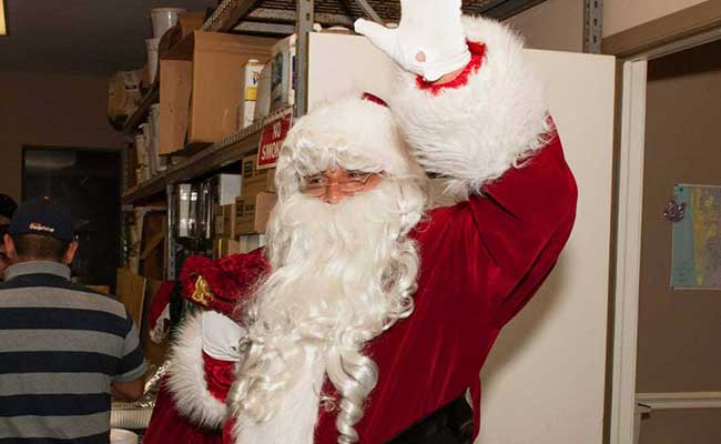 Santa arriving to the Greenling Roofing annual Christmas party | Naples Roofing Contractor
